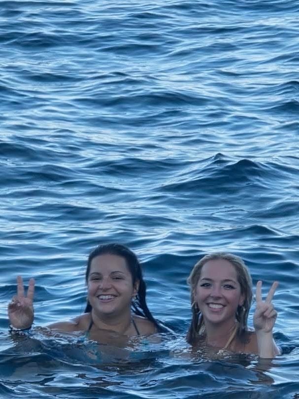 Holly and Melanie swimming together during an Ibiza boat party