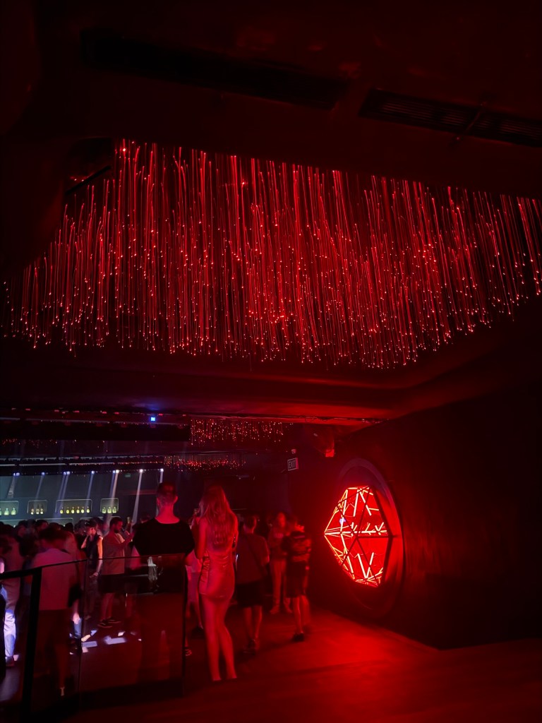 Red lights hanging above the crowd inside Pacha Ibiza
